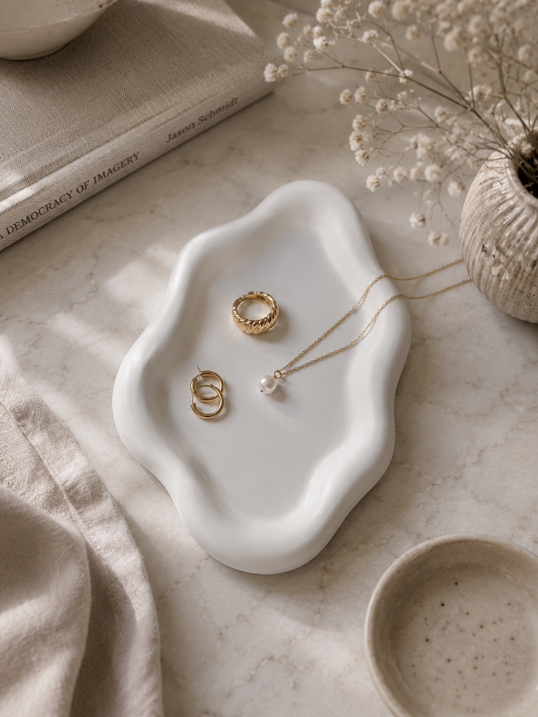 Oval Cloud sculptural tray styled on a dark console